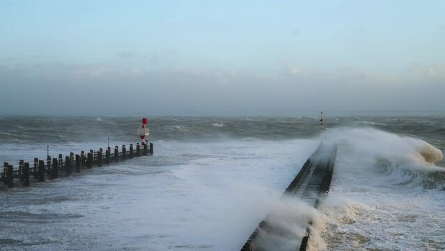 Waves overflowing above pier during storm Eunice, Vlissingen, Netherlands
