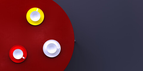 Three cups of different colors are on a red table