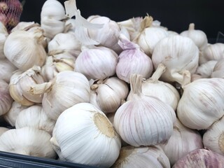 Top view of fresh garlics as a background for sale in the market, ready to cooking (Allium sativum)