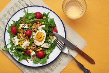 Green salad with tofu and chia seeds. Mixed salad with tofu hazelnuts and tofu on rustic table. Fresh diet salad served in plate.