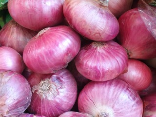 Top view of fresh red onion as a background for sale in the market, ready to cooking