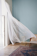 transparent fluttering curtain in the room with a candlestick on the table. romantic mood and...