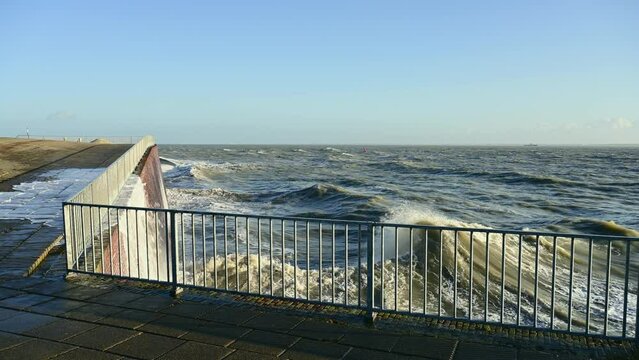 Waves crashing against pier during storm Franklin, Vlissingen, Netherlands