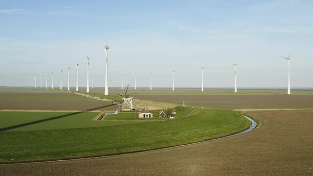 Wind turbines and windmill in field, Eemshaven, Netherlands
