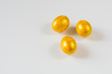 easter eggs of golden color on a white background isolated
