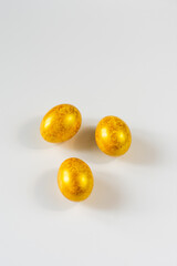 easter eggs of golden color on a white background isolated