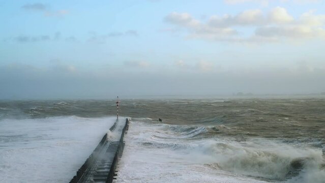 Waves overflowing above pier during storm Eunice, Vlissingen, Netherlands
