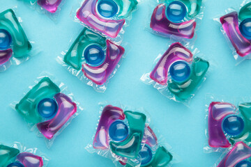 Laundry capsule detergent pods for washing clothes on blue background