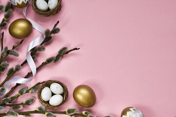 Flat lay Easter composition with willow branches, nest and eggs, white ribbon on a pink background. Happy easter postcard. Top view with copy space
