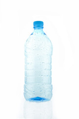 Empty wet transparent bottle isolated on white background. Blue plastic water packaging