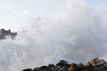 Storm waves crashing into rocks
