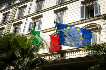 Italian and EU flag flags with old houses in the background