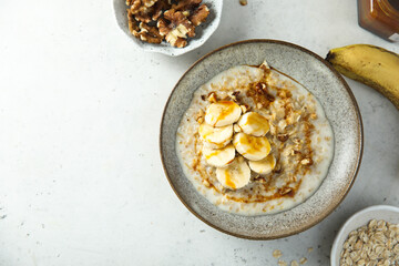Healthy oatmeal porridge with banana and walnut