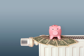 piggy bank and dollar bank notes on radiator, save heating costs and energy