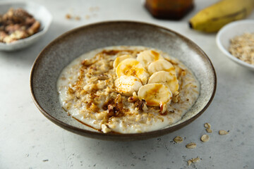 Healthy oatmeal porridge with banana and walnut