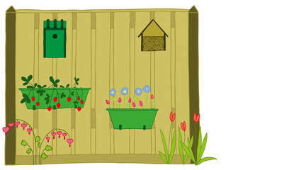 wooden fence with flowers, birdhouse and insect hotel