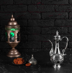 Fototapeta na wymiar arabic lamp and dried fruits on black background