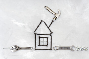 Fototapeta na wymiar House shape made from screws with a set of tools