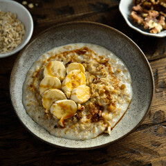 Healthy oatmeal porridge with banana and walnut