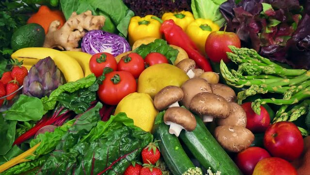 Colorful bunch of fresh vegetables and fruits with the camera moving around them. Symbol of healthy lifestyle and nutritious plant-based eating 
