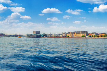 Big water canal with ships and boats, Royal Danish Playhouse and   old buildings warehouses on the waterfront. Copenhagen, Denmark