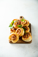 Homemade puff pastry swirls with bacon and tomato