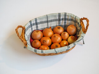 Onion and green onion in the basket on a white background