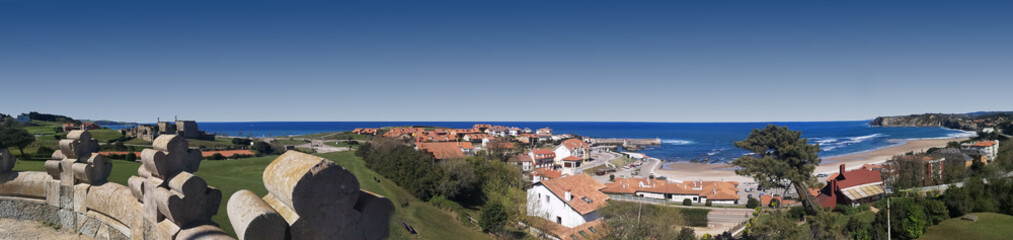 Naklejka na ściany i meble panoramic photo of the beach of Comillas, Cantabria,