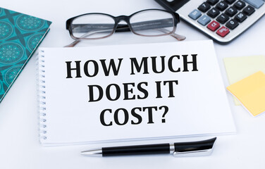 How Much Does it Cost. Business concept. Text on white notepad paper on light background