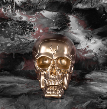 golden skull on gray abstract background