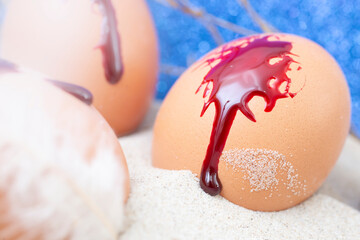 easter eggs painted with blood  in fine sand