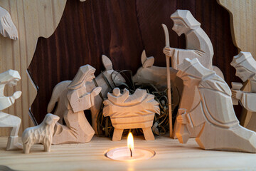 Christmas nativity scene with wooden figures. Mary, Joseph, shepherd and magi (three wise men) are...