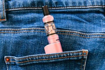 electronic cigarette in the pocket of jeans close-up