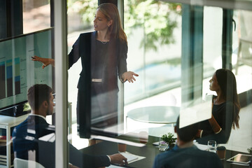 Taking stock and setting new targets. Shot of a corporate businessperson giving a presentation in the boardroom.