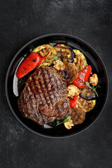 Grilled steak with baked vegetables and mushrooms