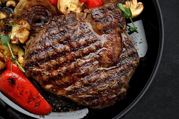 Grilled steak with baked vegetables and mushrooms