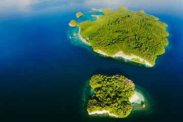 Fototapeta na wymiar The ocean is full of islands. High angle shot of beautiful green islands in the ocean.