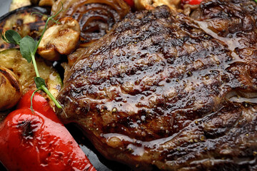 Grilled steak with baked vegetables and mushrooms