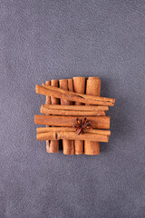 cinnamon sticks, star anise on blue background, copy space