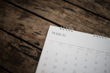 Blurred white calendar on wood texture. © toeytoey