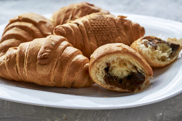 croissants with chocolate filling on a white plate close-up