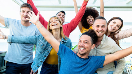 Group of multiracial people with hands up smiling at camera together - Corporate team colleagues congratulating coworker with business success in coworking shared office - obrazy, fototapety, plakaty