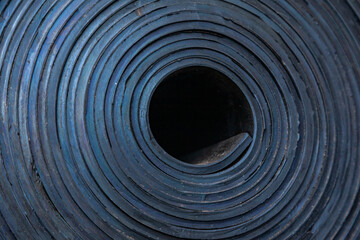 Fototapeta na wymiar Industrial, new, black rubber twisted into a roll, close-up.