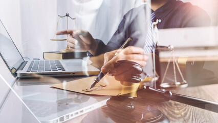 Male lawyer working with contract papers and wooden gavel on tabel in courtroom. justice and law ,attorney, court judge, concept.