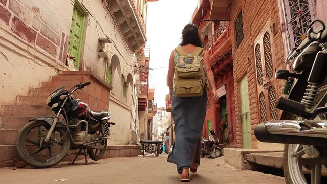 Female tourist walks through the streets of an Indian city. Rajasthan, Indian Jodhpur Also blue city