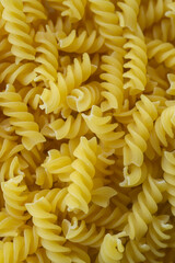 Uncooked fusilli pasta as background