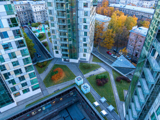 Top view on modern city building complex with autumn green