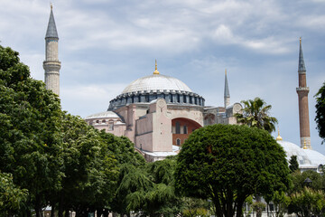 Fototapeta na wymiar Hagia Sophia, Hagia Sophia view among blue sky and green trees, mosque or church or museum, local name is turkish 