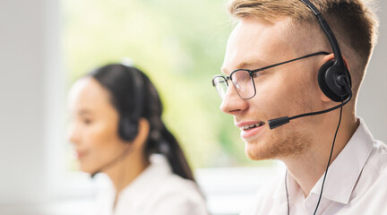 Team of professional support staff working in the office. Colleagues in the workplace solve customer problems. Call center and customer support concept.