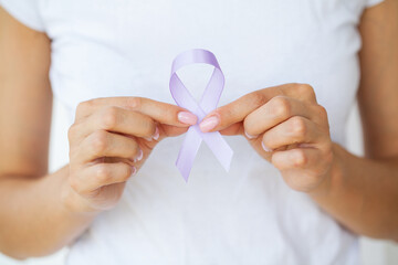 Woman with blue ribbon, prostate cancer awareness